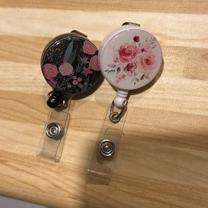 Two floral badge reels